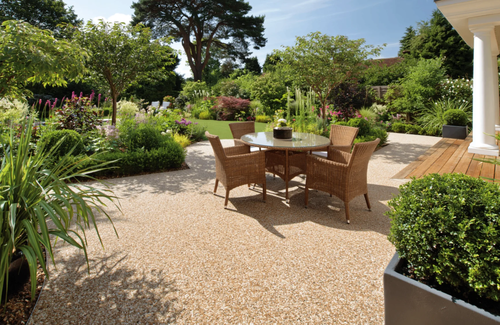 Resin bound patio with garden dining furniture in a landscaped rear garden