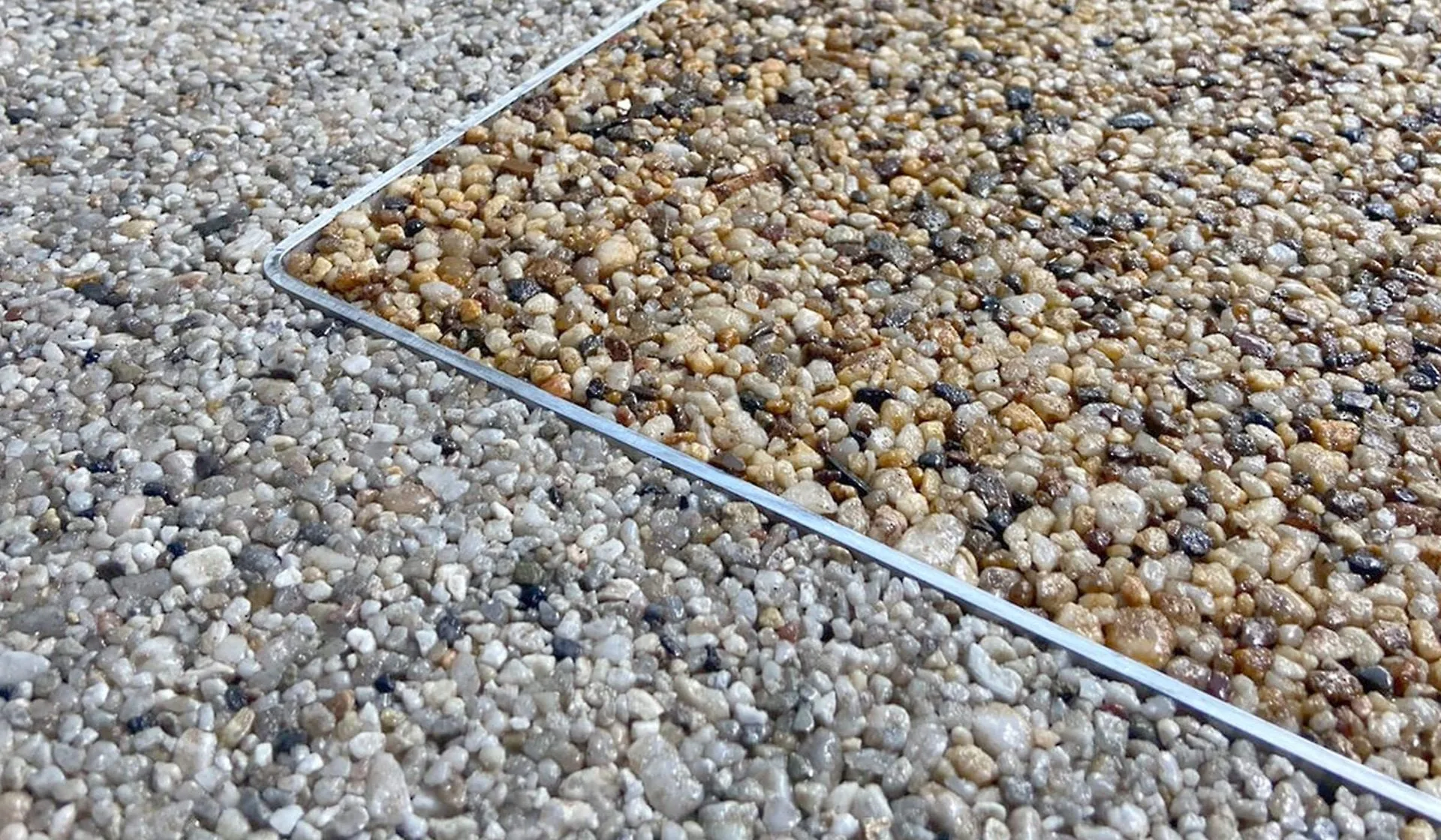Close-up of resin bound aggregate showing seamless texture used around pool surrounds